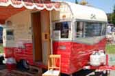 Restored 1960 vintage Shasta Airflyte trailer has a beautiful orange and white paint job